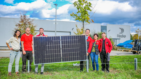 a group of people standing in front of a sign